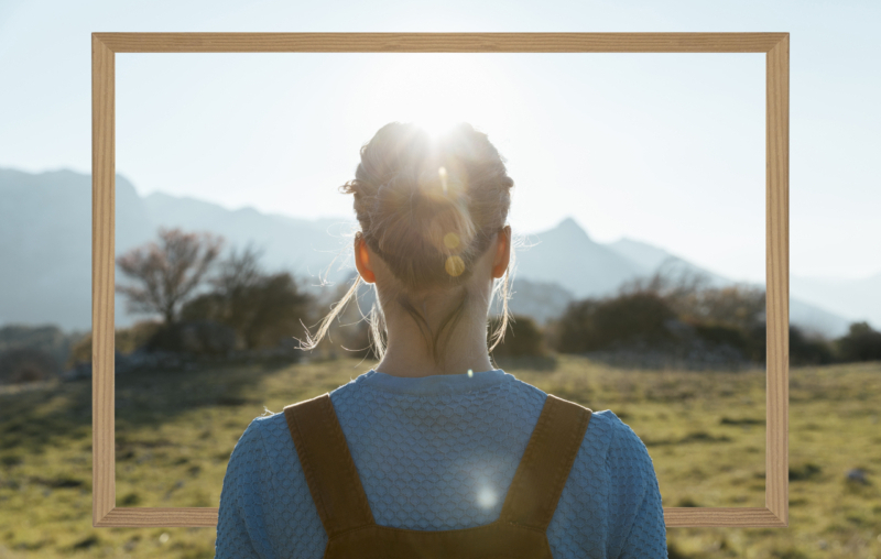 person-holding-frame-with-open-nature-landscape-concept